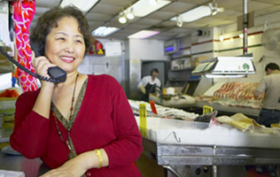 woman on the phone inside her business