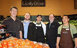 business owners standing in their grocery store